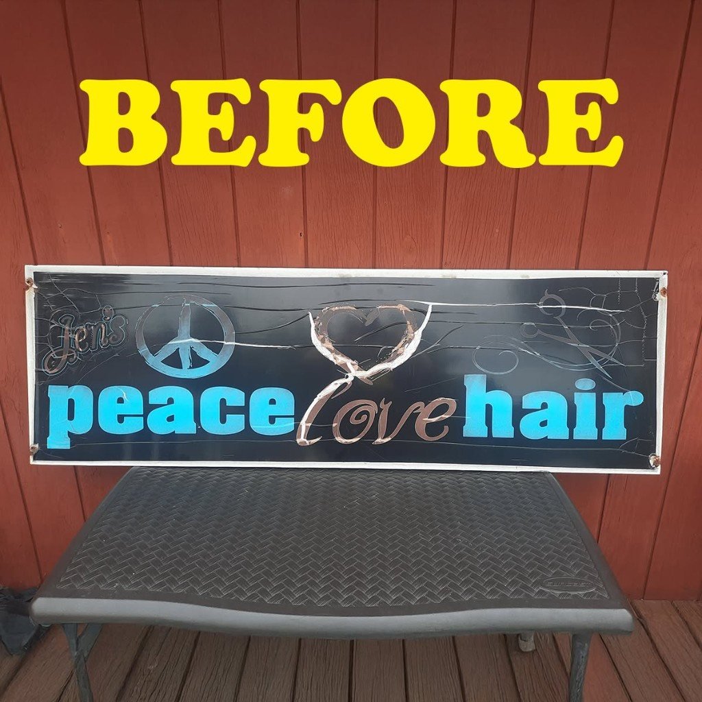 Jen's peace love hair salon sign before — cracked and peeling